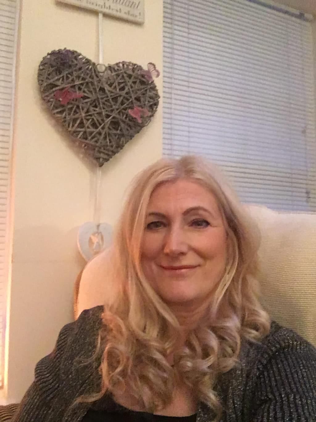 Individual therapy with Sonya Hudson Sonya Hudson relaxing in her therapy room beneath a woven heart decoration